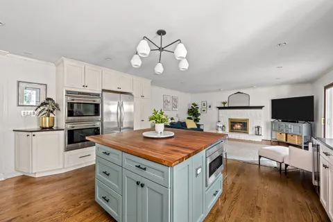 a kitchen that has a table and chairs in it