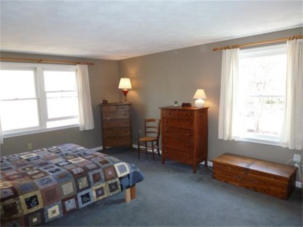29 Concord Road Bedford, MA 01730 - Photo 11 of 24 a bedroom with a bed and a window