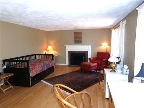29 Concord Road Bedford, MA 01730 - Photo 14 of 24 a living room with furniture and a fireplace