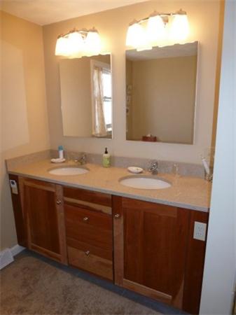 29 Concord Road Bedford, MA 01730 - Photo 20 of 24 a bathroom with a double vanity sink and a mirror