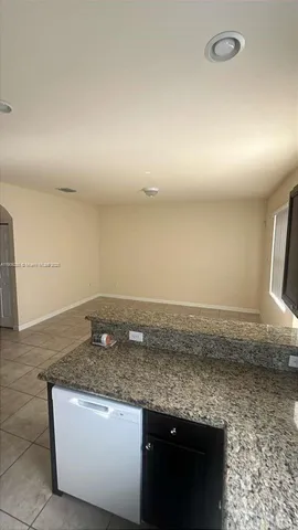 a view of a kitchen with granite countertop a sink and a granite counter tops