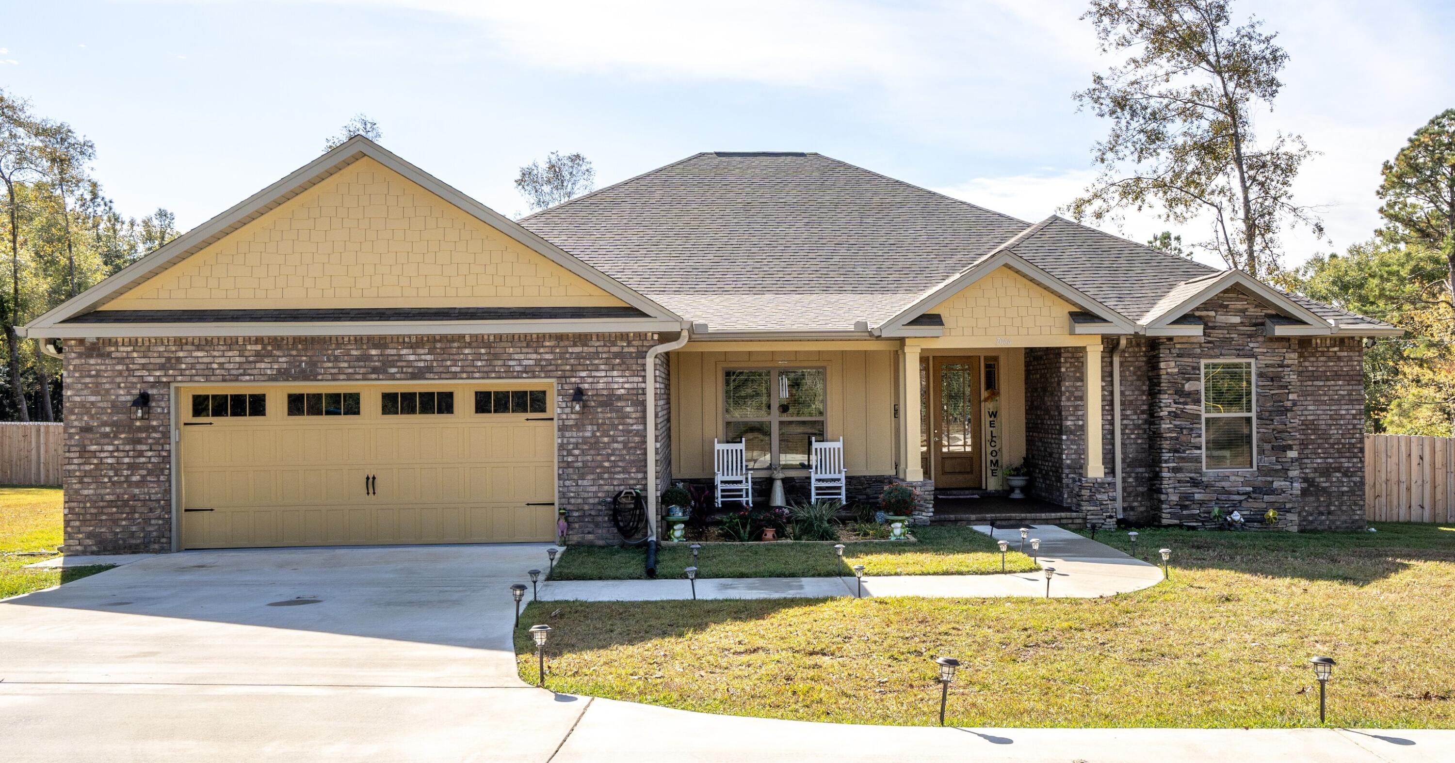 7066 Senterfitt Road Laurel Hill, FL 32567 - Photo 1 of 59 a front view of a house with garden