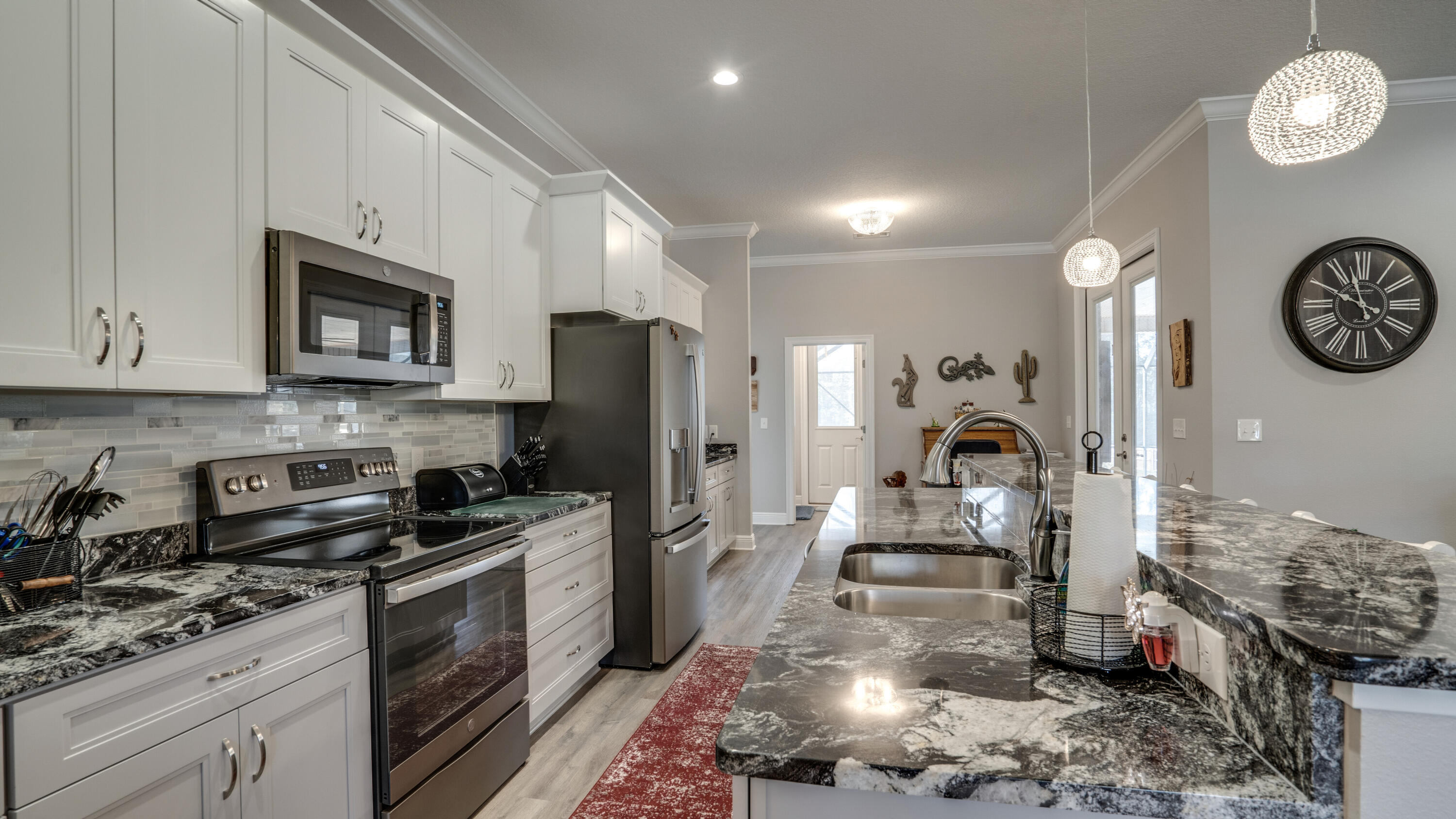 7066 Senterfitt Road Laurel Hill, FL 32567 - Photo 11 of 59 a kitchen with a sink stove and refrigerator
