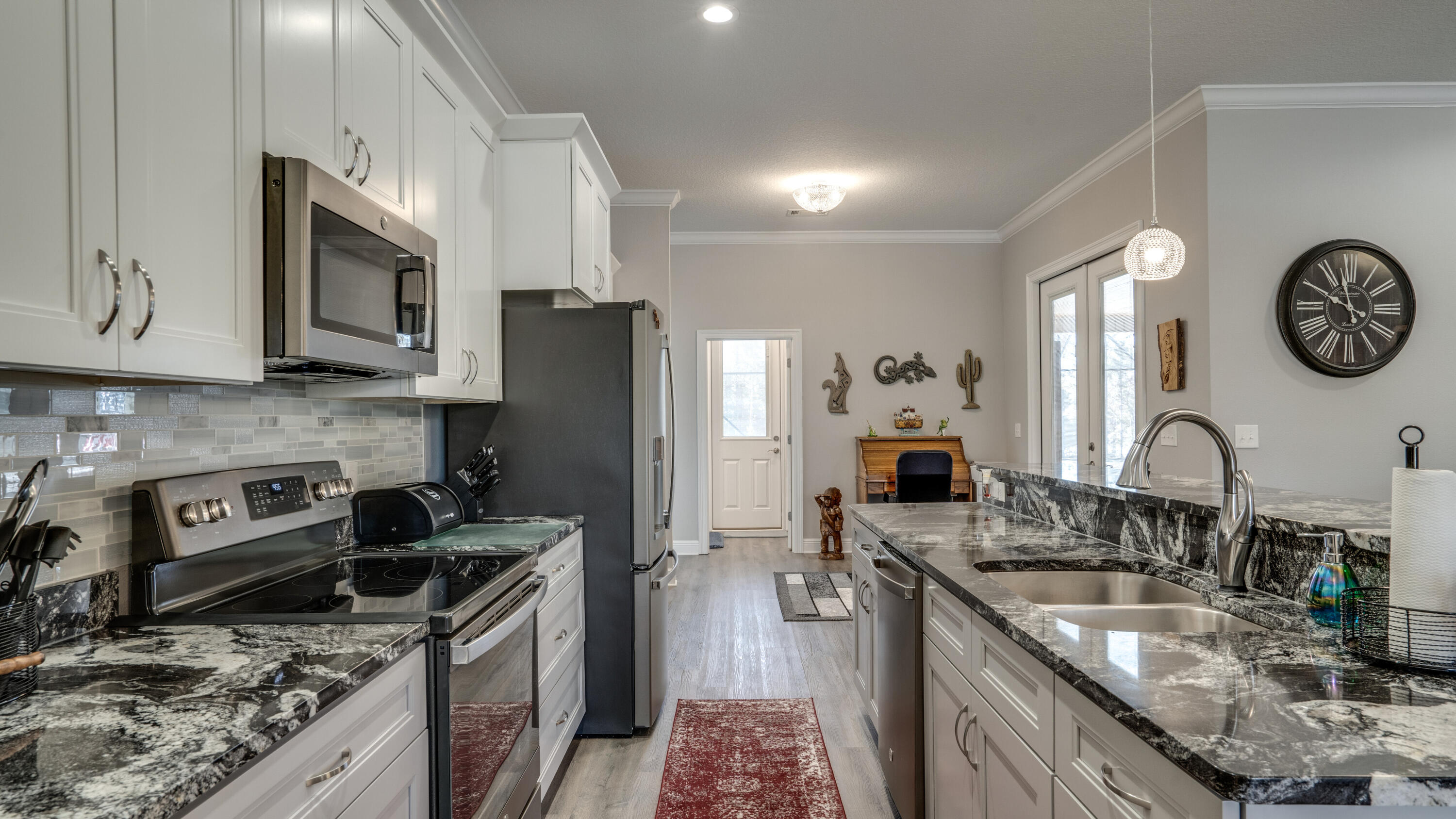 7066 Senterfitt Road Laurel Hill, FL 32567 - Photo 12 of 59 a kitchen with stainless steel appliances granite countertop a sink stove and refrigerator
