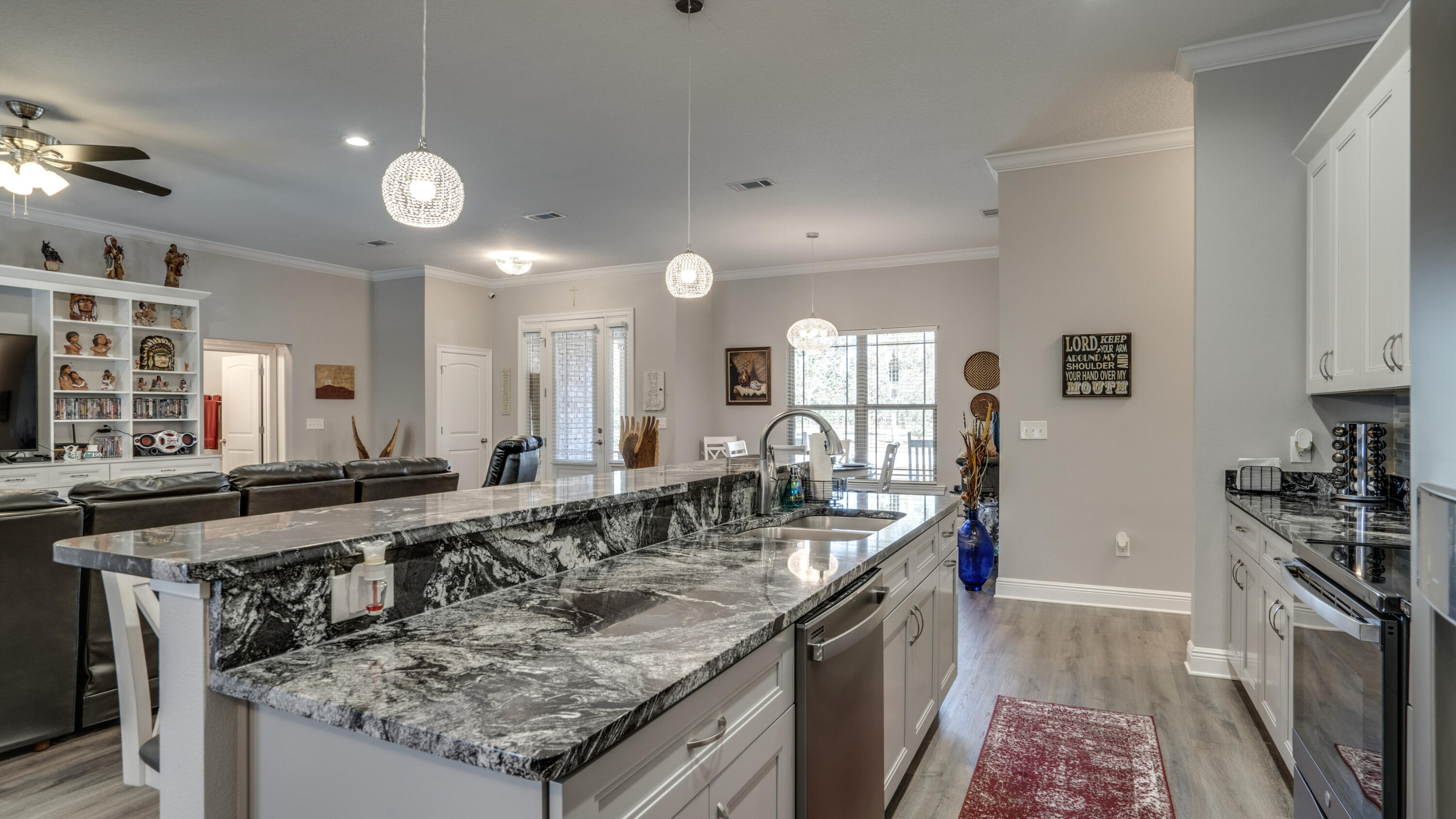 7066 Senterfitt Road Laurel Hill, FL 32567 - Photo 13 of 59 a large kitchen with a counter top space a sink stainless steel appliances and cabinets