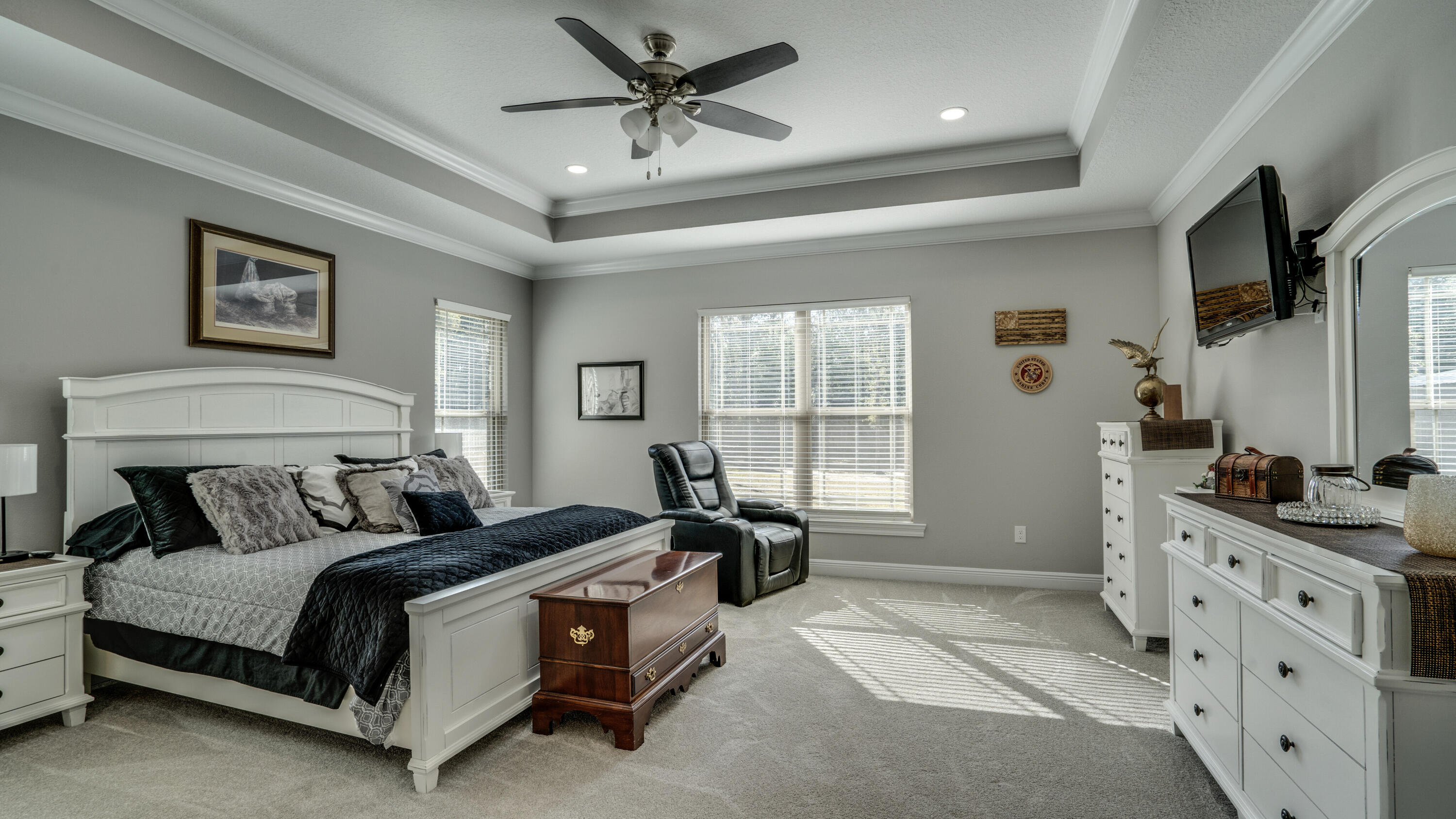7066 Senterfitt Road Laurel Hill, FL 32567 - Photo 18 of 59 a bedroom with a bed a dresser and with a flat tv screen