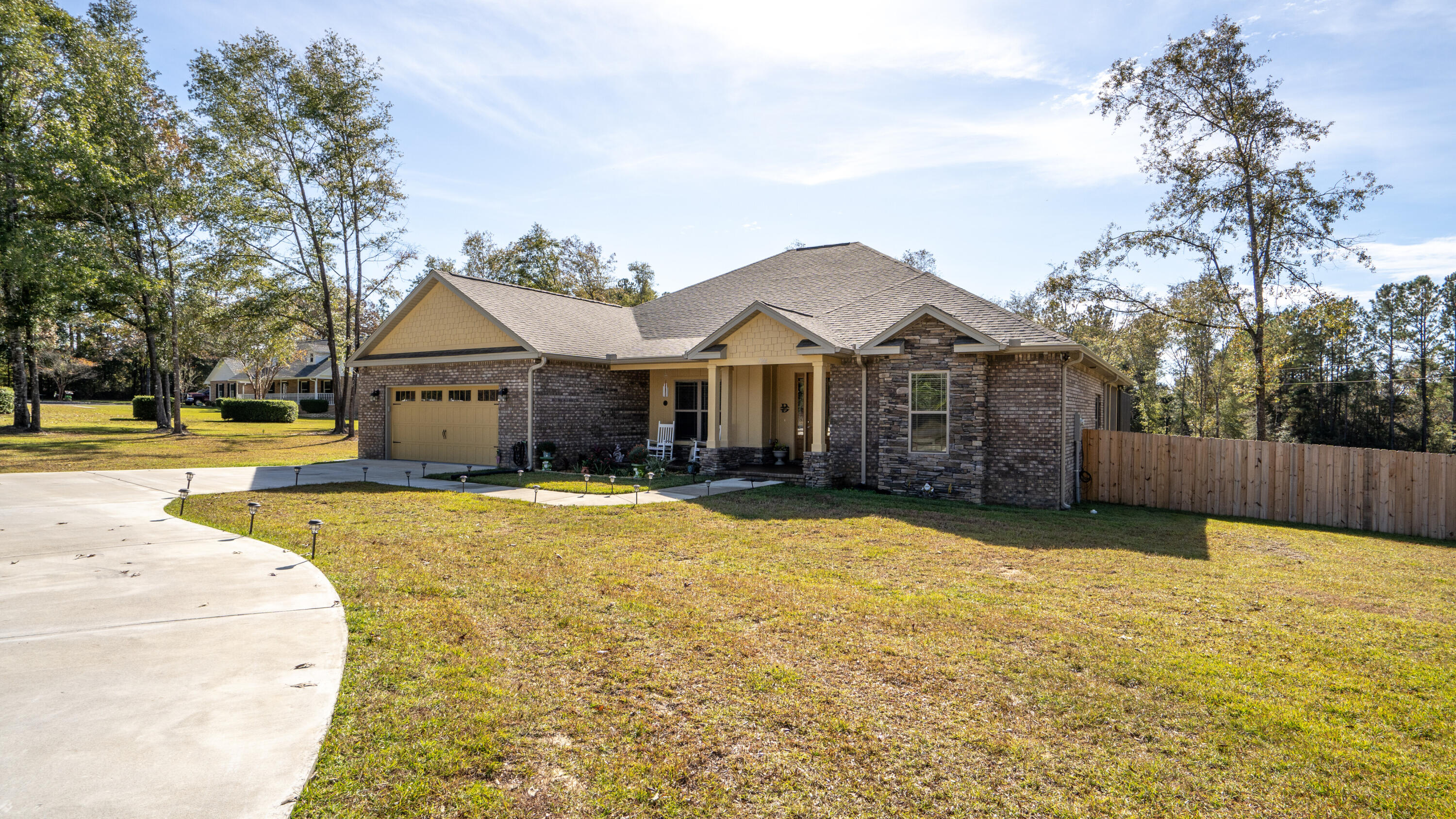 7066 Senterfitt Road Laurel Hill, FL 32567 - Photo 2 of 59 a view of a house with a yard and a large tree