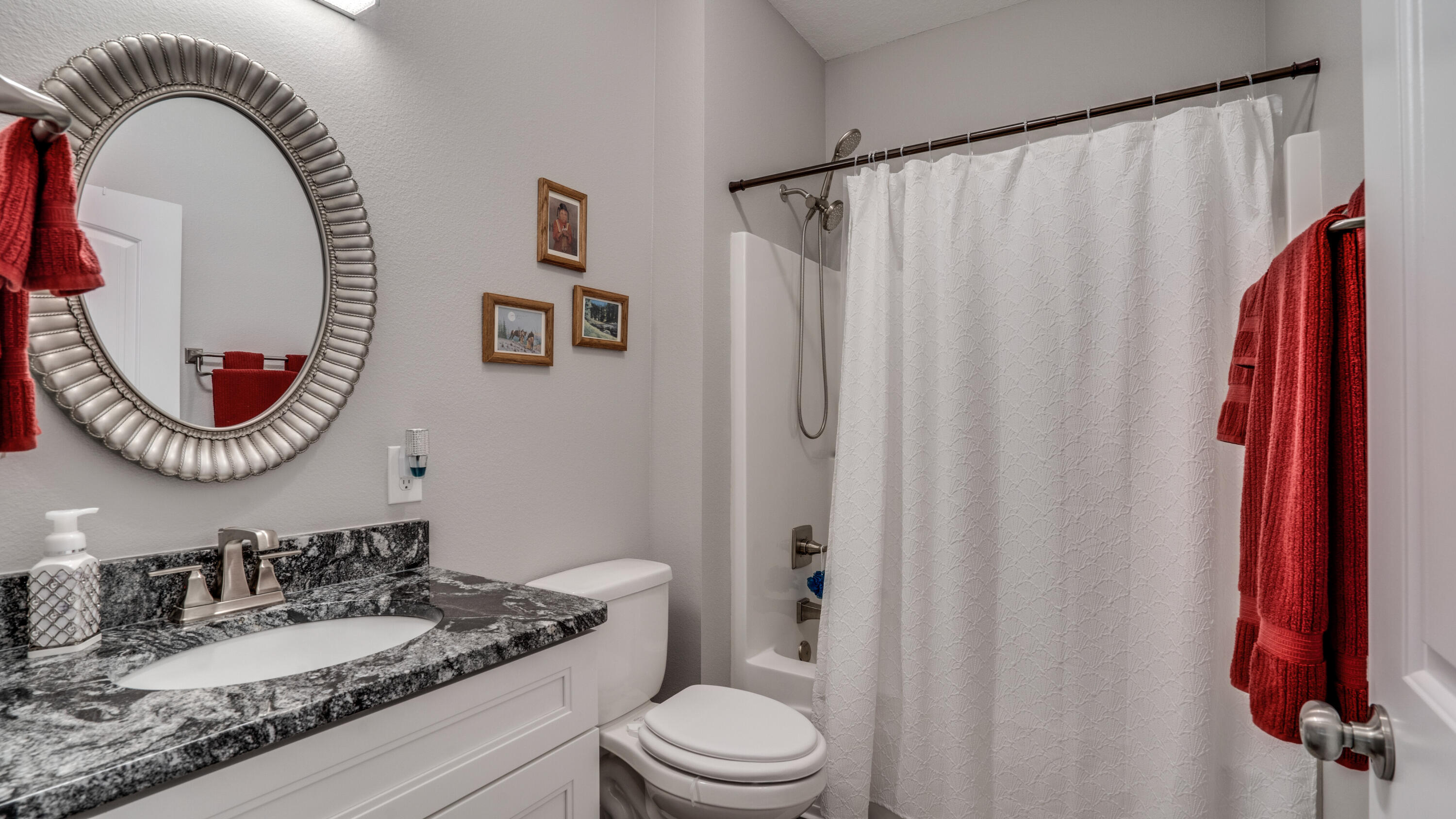 7066 Senterfitt Road Laurel Hill, FL 32567 - Photo 25 of 59 a bathroom with a toilet a sink and a mirror