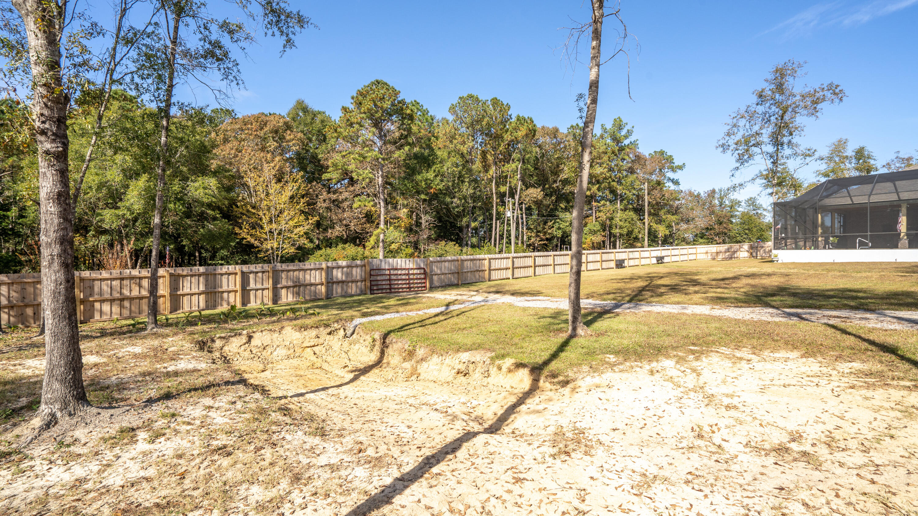 7066 Senterfitt Road Laurel Hill, FL 32567 - Photo 42 of 59 a view of a swimming pool with a yard