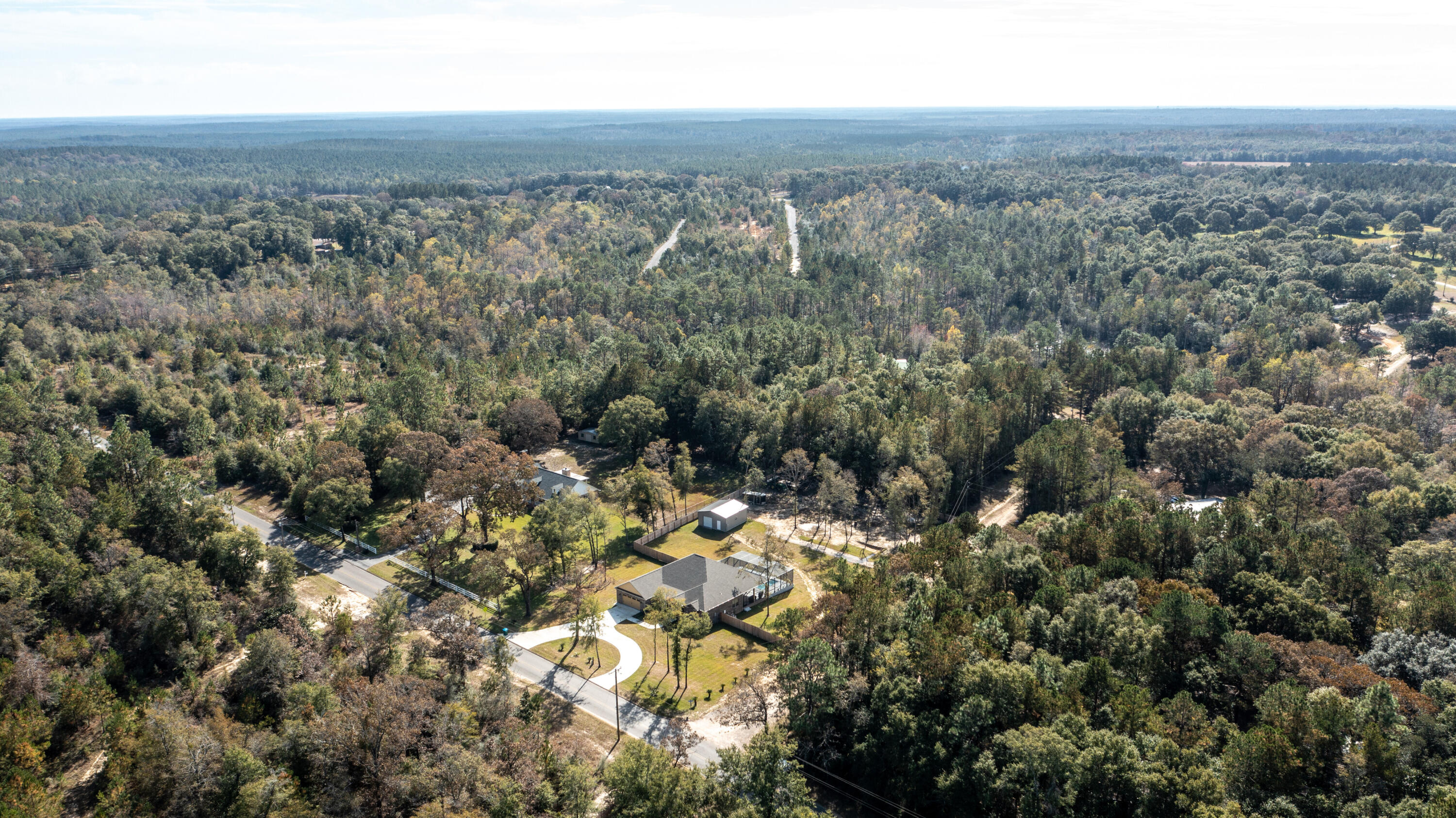 7066 Senterfitt Road Laurel Hill, FL 32567 - Photo 57 of 59 an aerial view of house with yard and mountain in the background