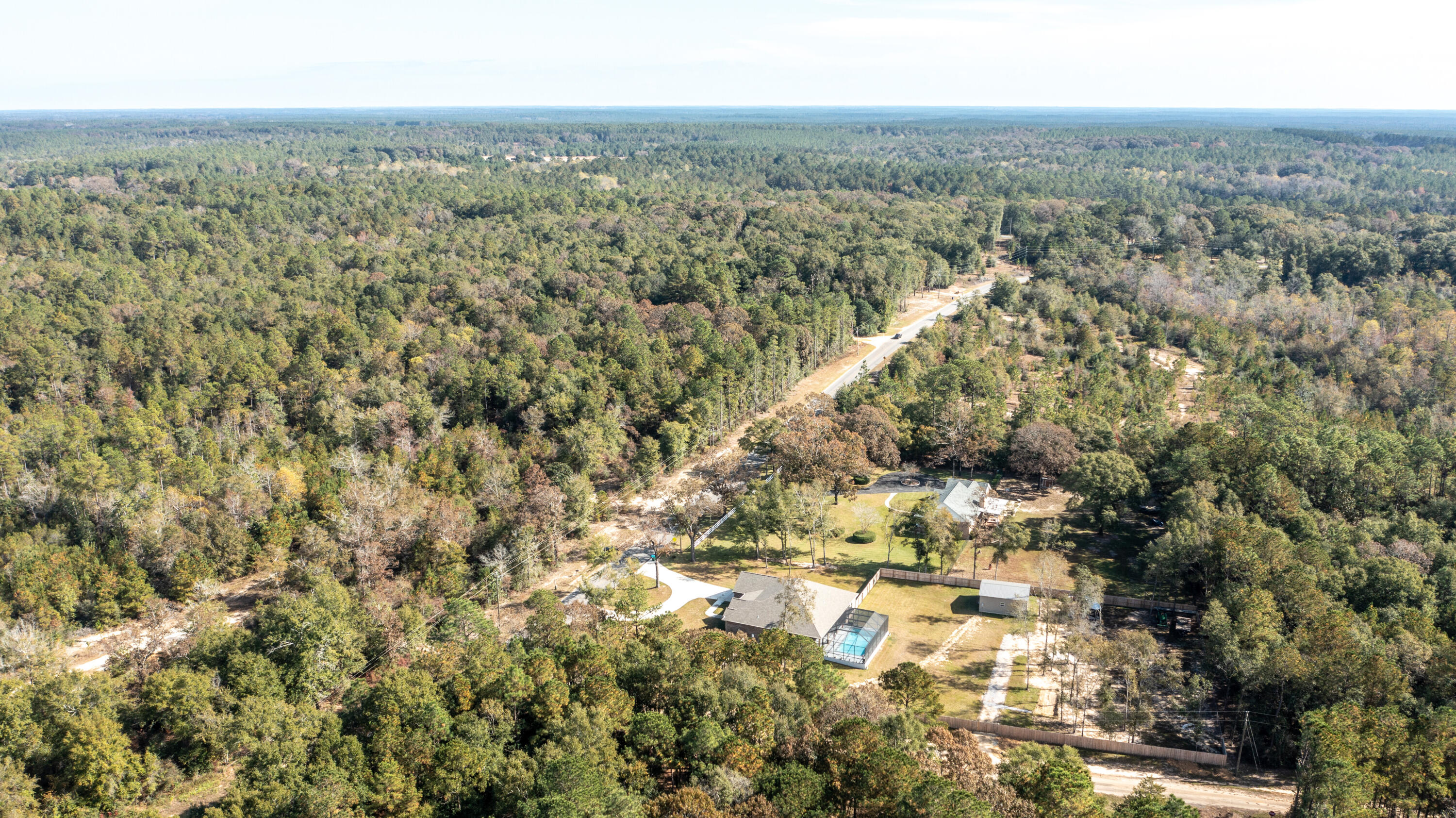 7066 Senterfitt Road Laurel Hill, FL 32567 - Photo 58 of 59 an aerial view of house with yard and mountain view in back