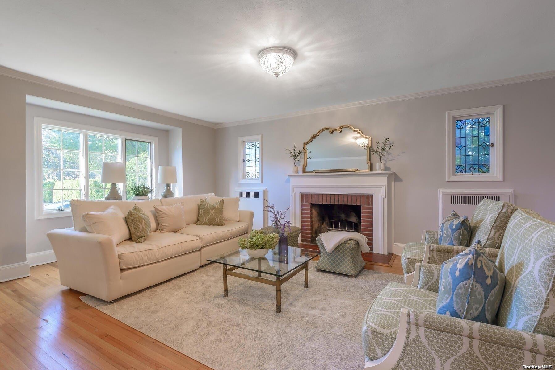 47 Shoreview Road Manhasset, NY 11030 - Photo 1 of 1 a living room with furniture and a fireplace