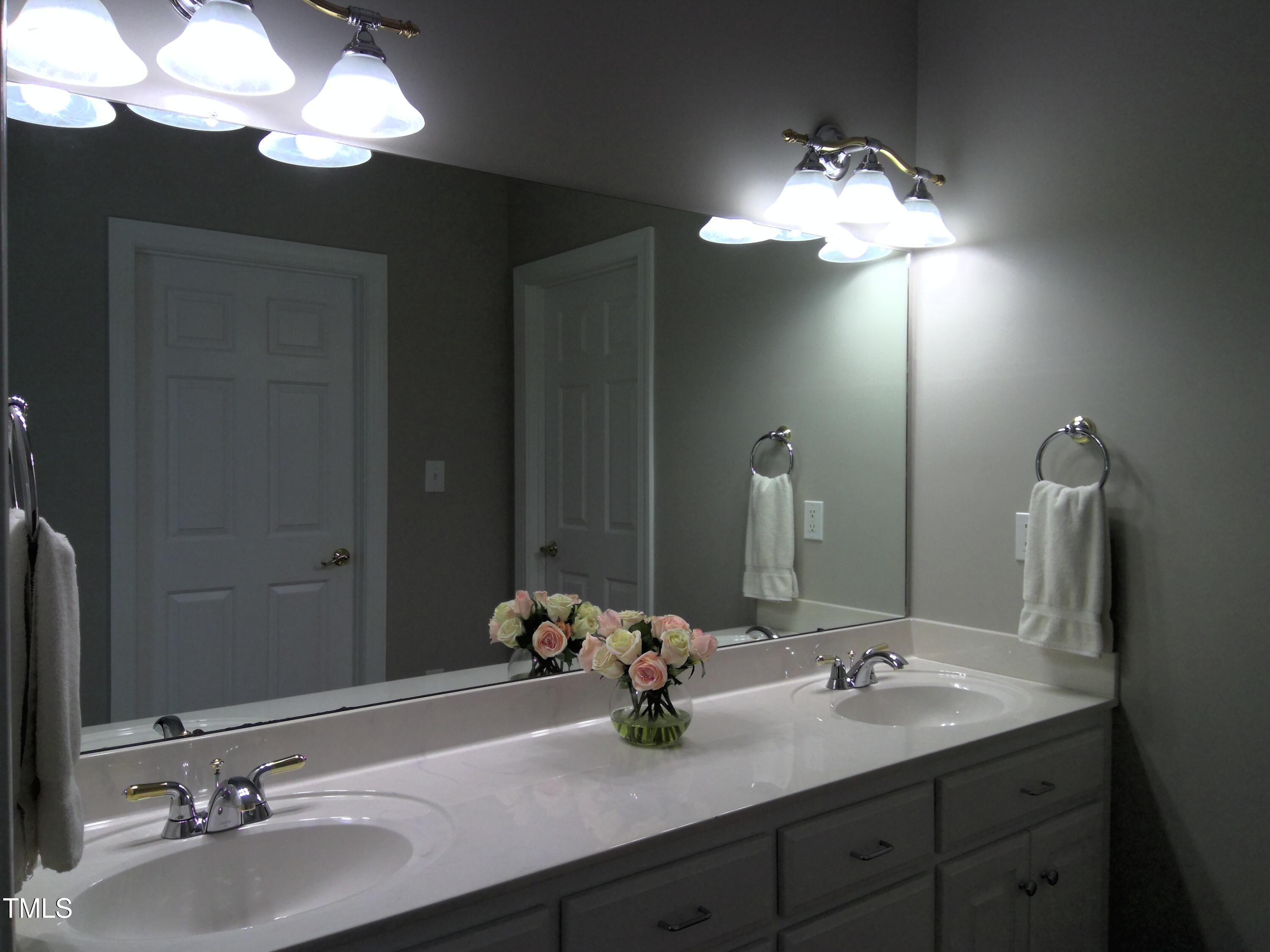 12 Crail Court Durham, NC 27712 - Photo 12 of 29 a bathroom with double vanity sinks and a mirror