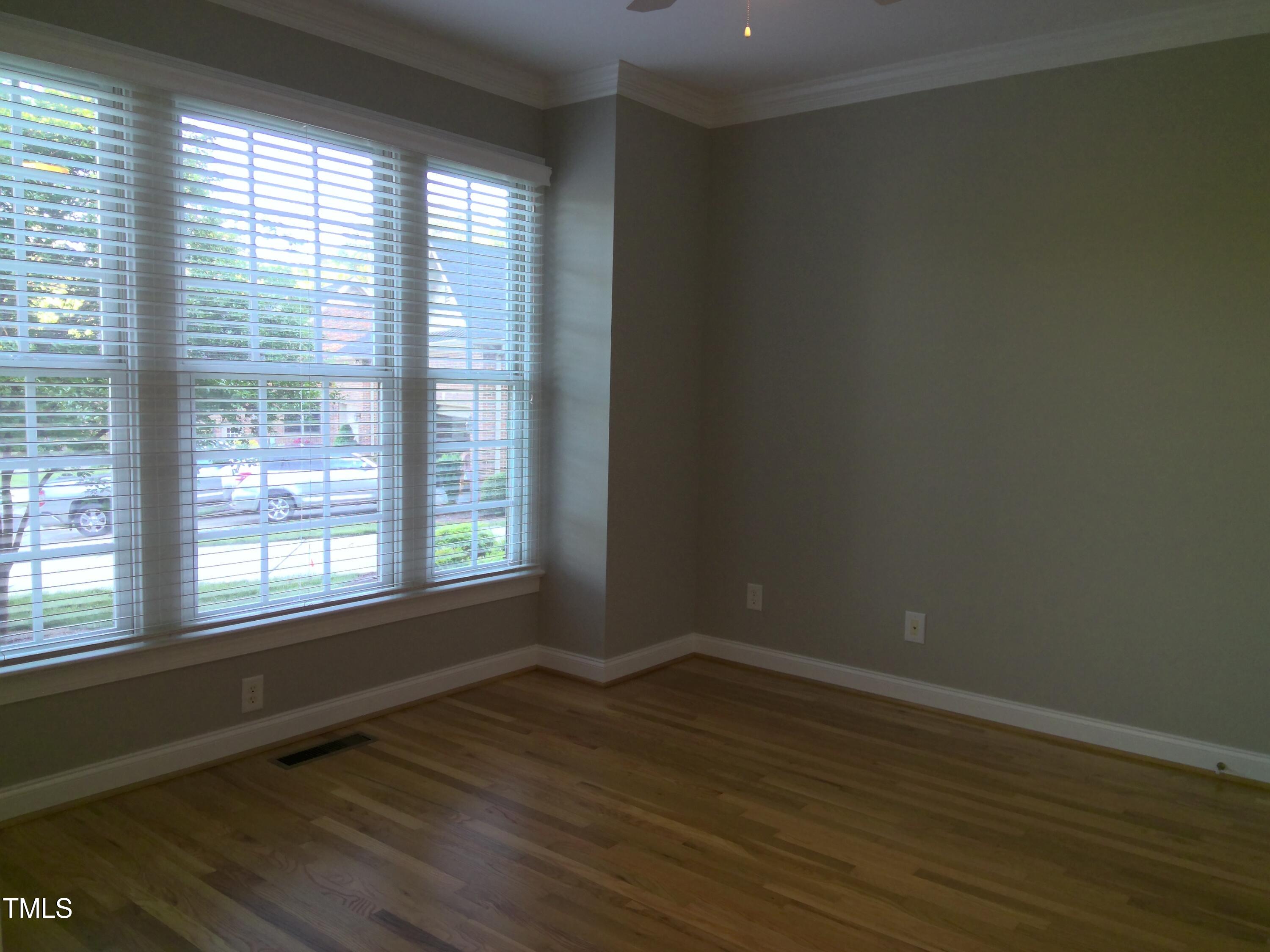 12 Crail Court Durham, NC 27712 - Photo 15 of 29 a view of an empty room with wooden floor and a window