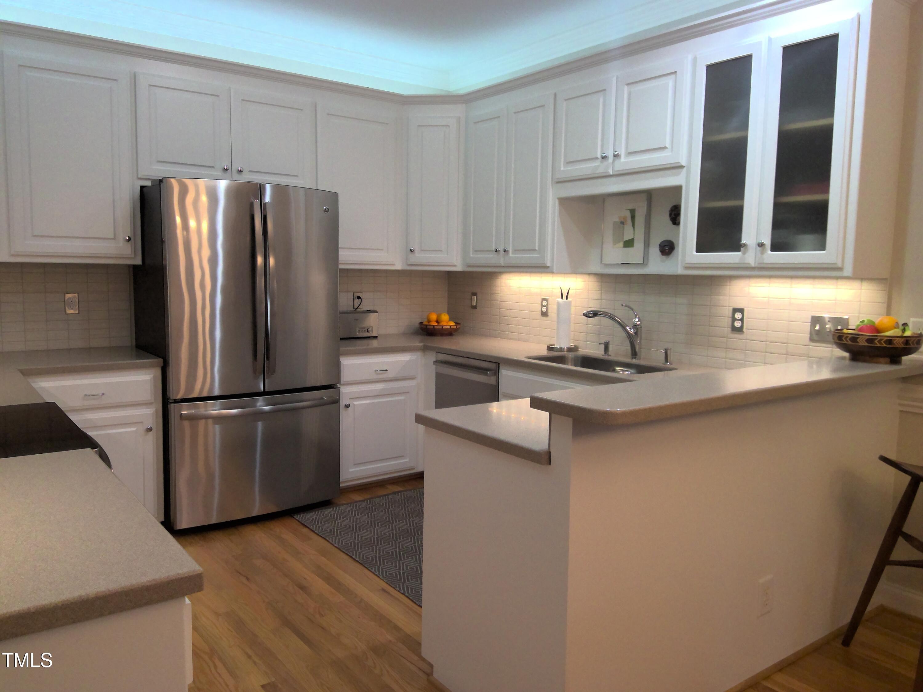 12 Crail Court Durham, NC 27712 - Photo 9 of 29 a kitchen with a refrigerator sink and cabinets