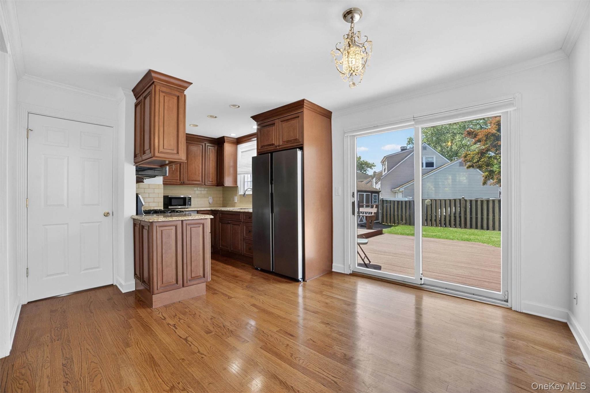 263 Croydon Road Yonkers, NY 10710 - Photo 8 of 43 a kitchen with kitchen island wooden floor and refrigerator