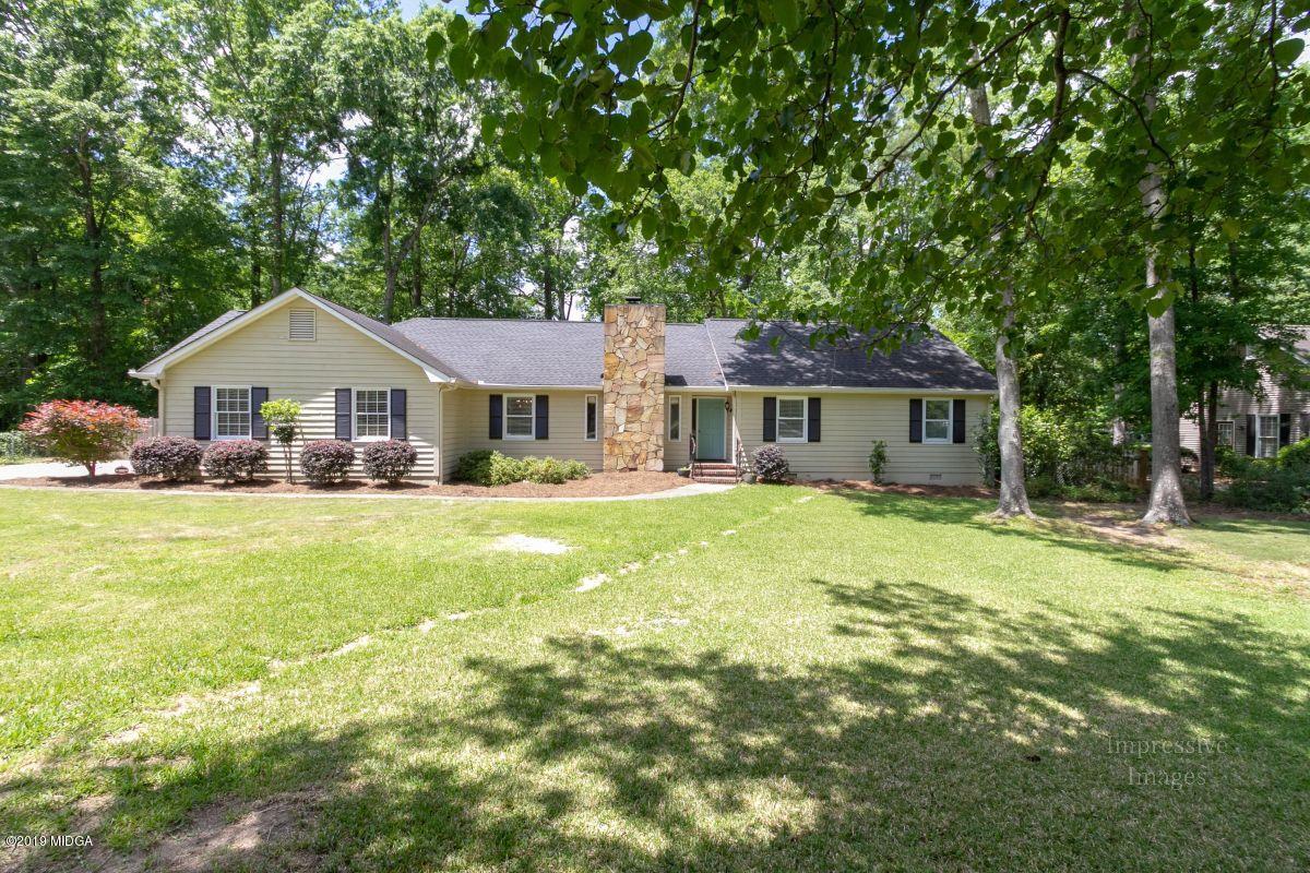 180 Castlegate Road Macon, GA 31210 - Photo 1 of 23 a front view of a house with a yard plants and trees