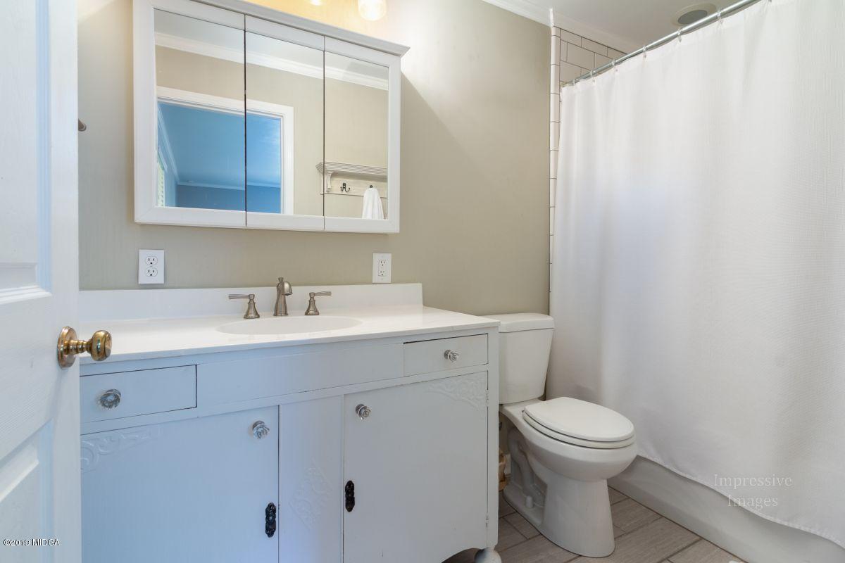 180 Castlegate Road Macon, GA 31210 - Photo 13 of 23 a bathroom with a sink a toilet and mirror