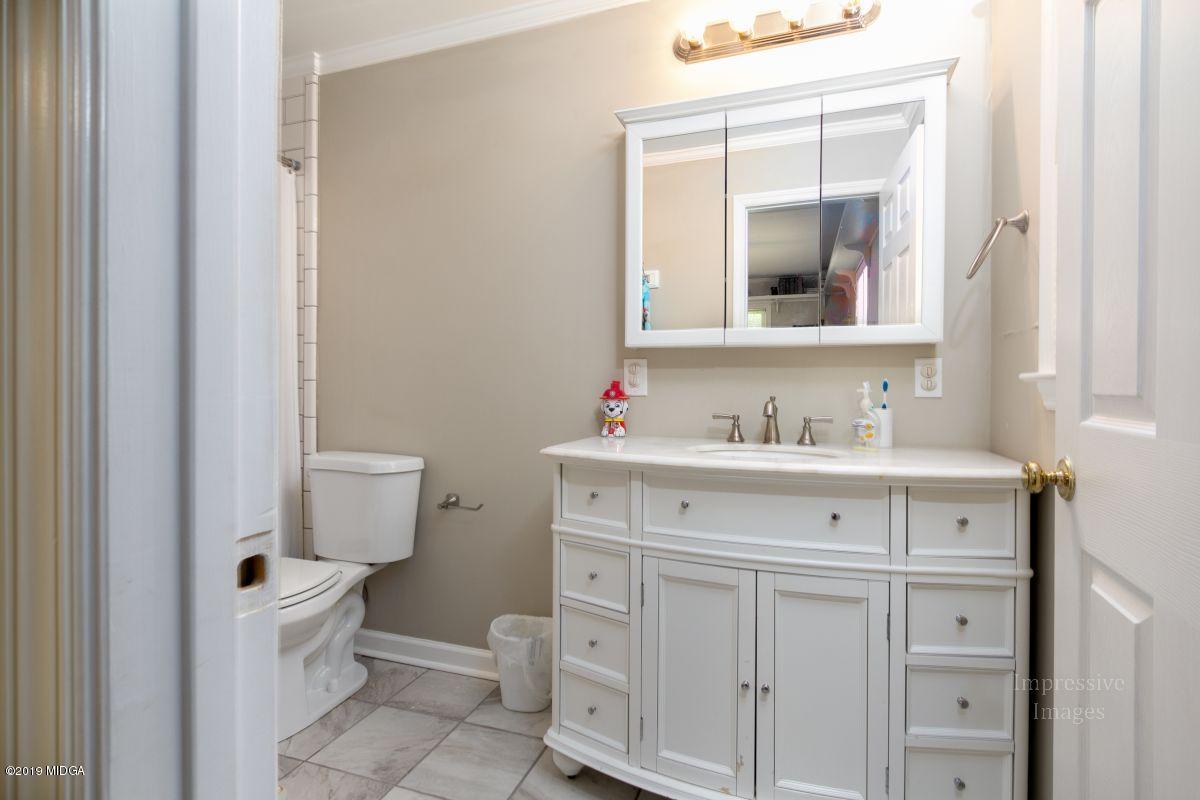 180 Castlegate Road Macon, GA 31210 - Photo 17 of 23 a bathroom with a sink vanity and a toilet