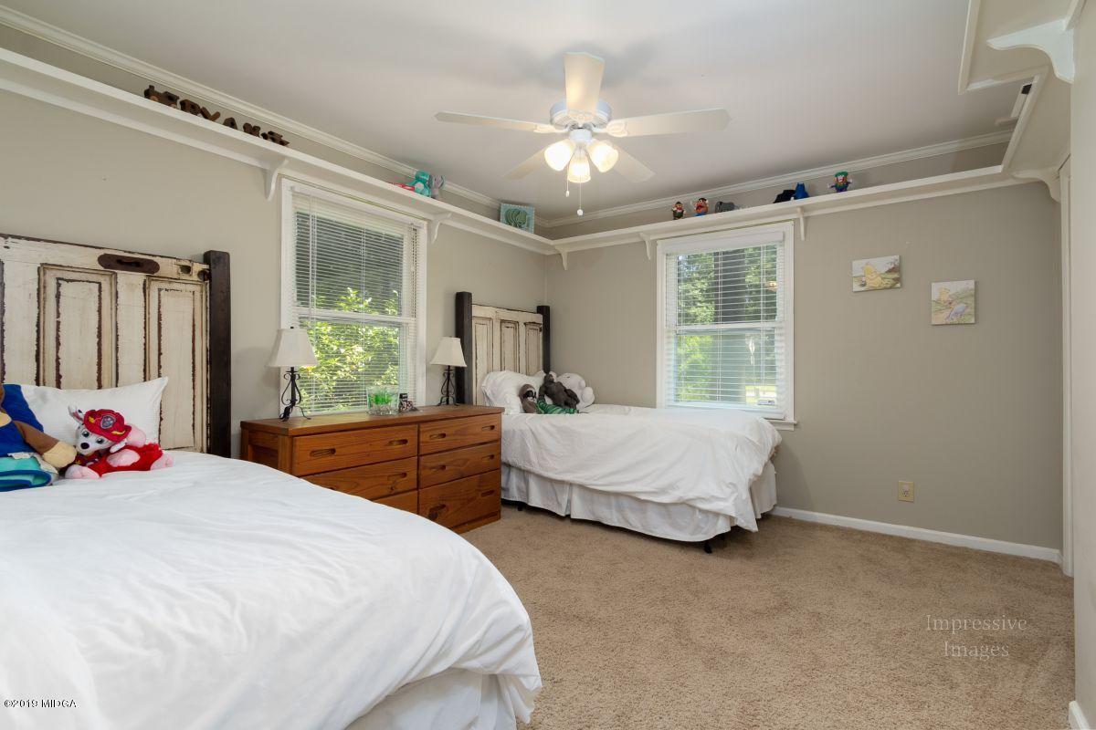 180 Castlegate Road Macon, GA 31210 - Photo 18 of 23 a bedroom with a bed closet and large window