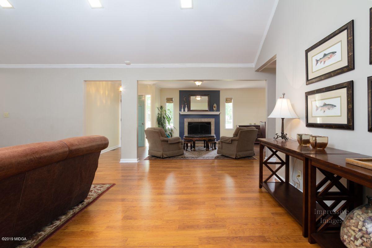 180 Castlegate Road Macon, GA 31210 - Photo 5 of 23 a living room with furniture a fireplace and a flat screen tv