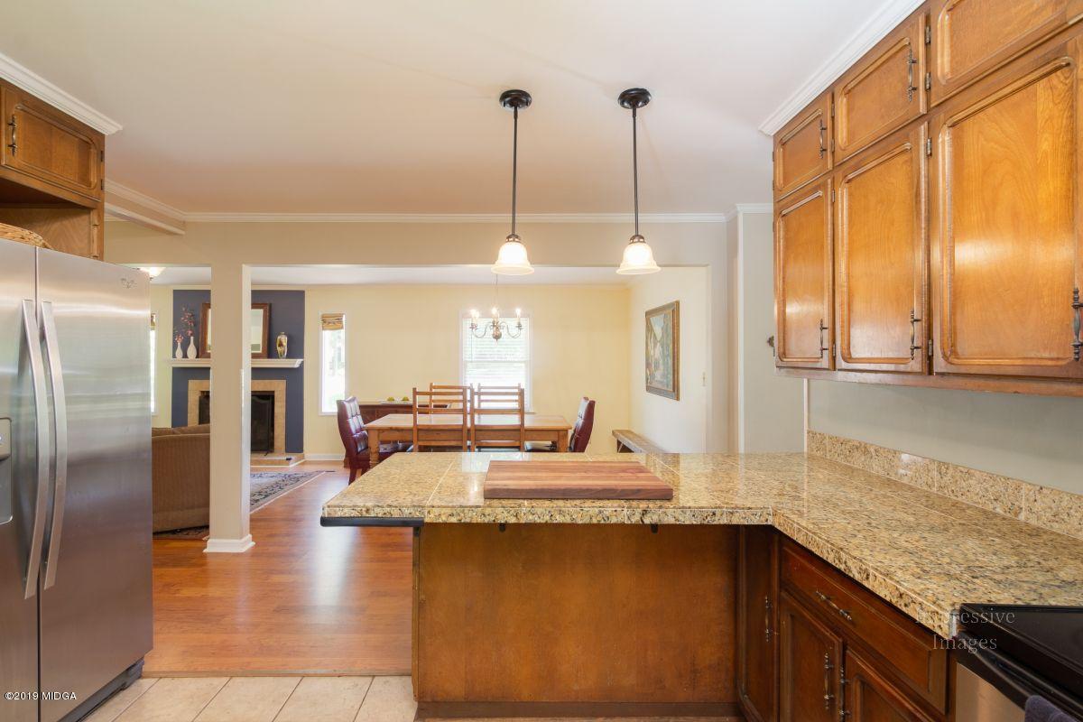 180 Castlegate Road Macon, GA 31210 - Photo 10 of 23 a kitchen with kitchen island a counter top space a sink stainless steel appliances and cabinets