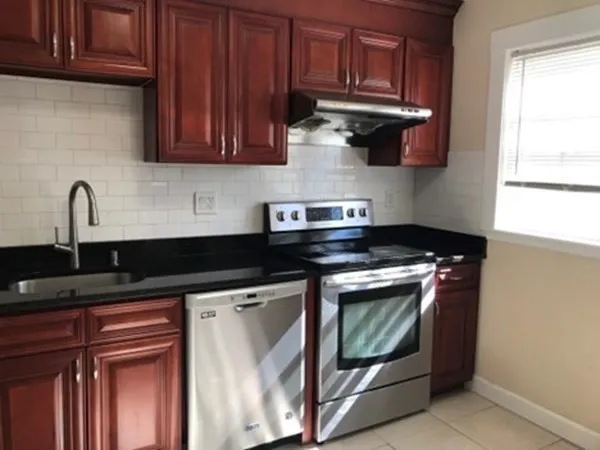 a kitchen with stainless steel appliances granite countertop a stove and a microwave