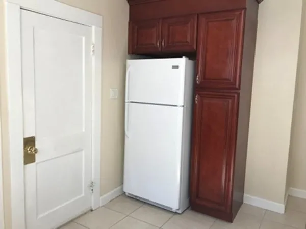 a white refrigerator freezer sitting in a kitchen