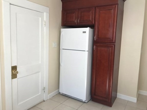 139 Pine Street, Unit 1/F Quincy, MA 02170 - Photo 6 of 10 a white refrigerator freezer sitting in a kitchen