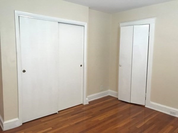 139 Pine Street, Unit 1/F Quincy, MA 02170 - Photo 7 of 10 a view of an empty room with wooden floor