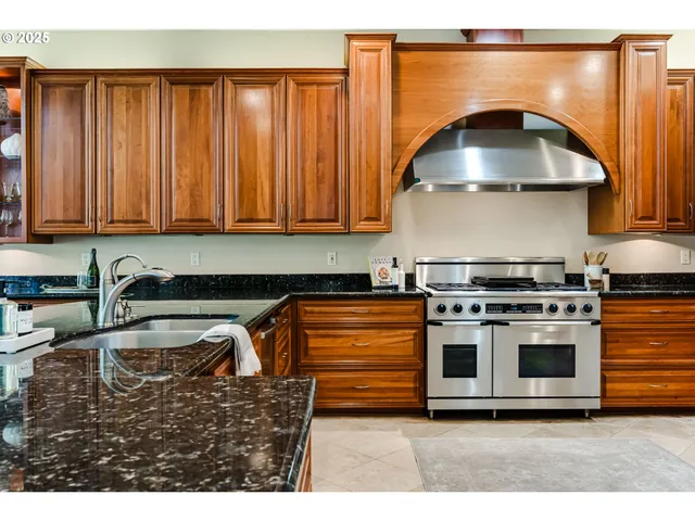 a kitchen with granite countertop a stove and a sink