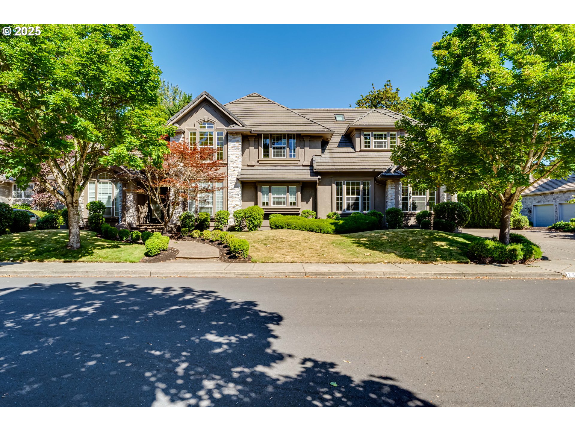 2874 Riverwalk Loop Eugene, OR 97401 - Photo 2 of 48 a front view of a house with a yard and a garage