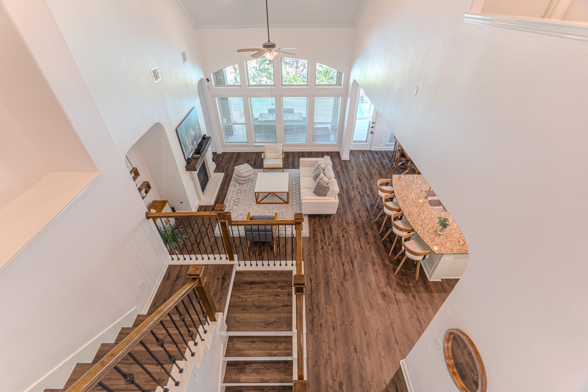 30 Fury Ranch Place The Woodlands, TX 77375 - Photo 31 of 47 This home features a welcoming foyer with elegant wood flooring and a stylish staircase with wrought iron railings. The high ceilings and open layout enhance the spacious feel, while large windows allow plenty of natural light. Ideal for a modern lifestyle.