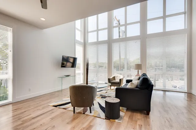 a living room with furniture water view and large windows