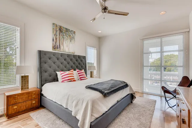 a bedroom with a large bed and a window