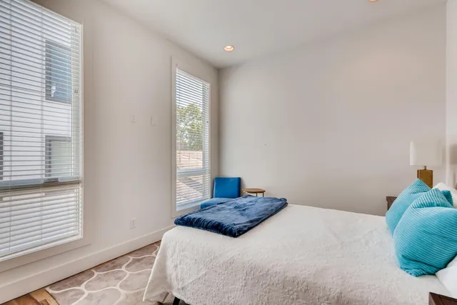 a bedroom with a large bed and a window