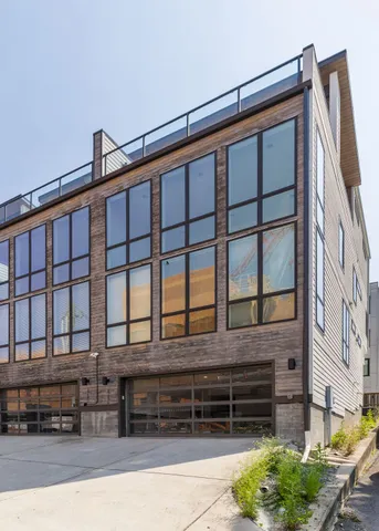 a front view of a building with cars