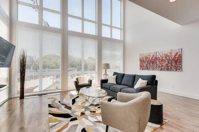 a living room with furniture and a large window with outer view