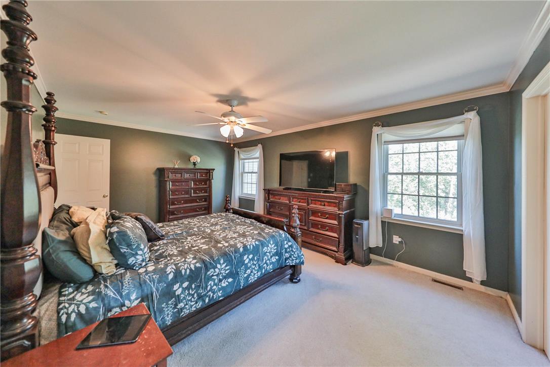 63 Long Road Lenhartsville, PA 19534 - Photo 89 of 100 An airy bedroom highlights elegant crown molding and wall-to-wall carpeting.
