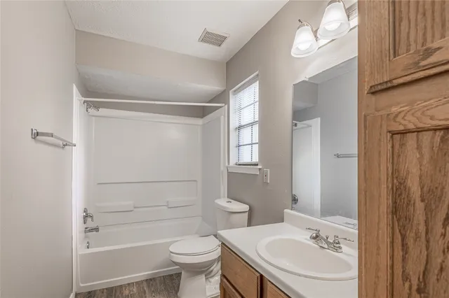 a bathroom with a sink toilet a mirror and shower