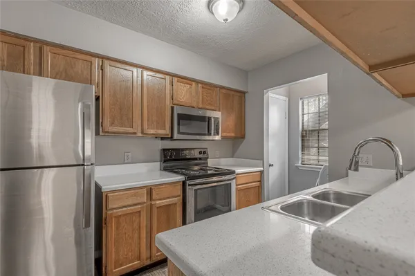 a kitchen with a refrigerator sink and microwave