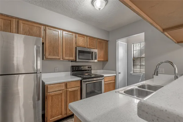 a kitchen with a refrigerator sink and microwave