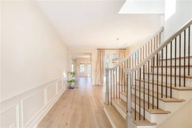 a view of entryway and hall with wooden floor