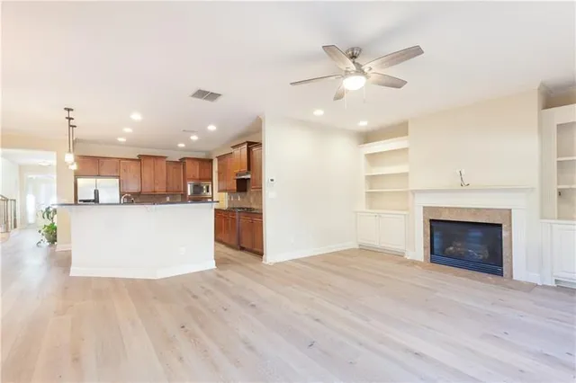 a view of a kitchen with a sink dishwasher and a fireplace