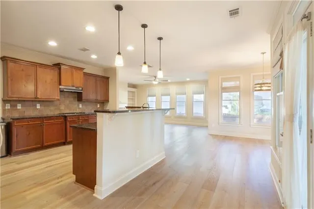 a kitchen with stainless steel appliances granite countertop refrigerator sink and stove
