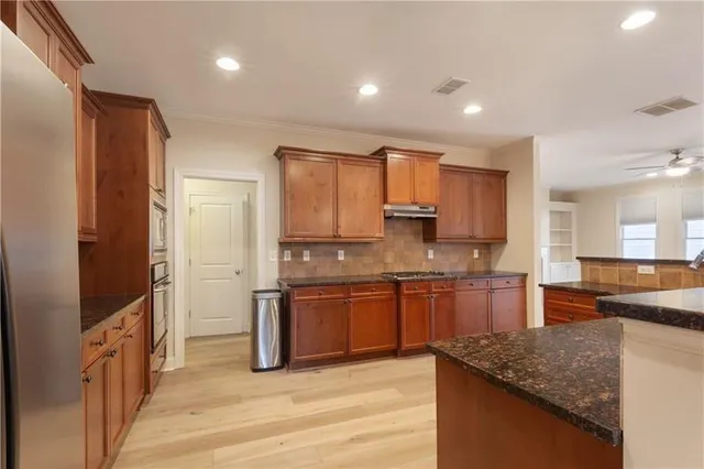 a view of a kitchen with a sink and a refrigerator
