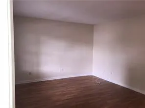 a view of an empty room and wooden floor