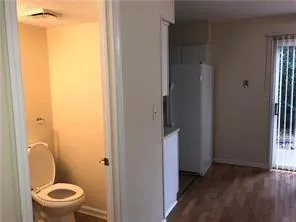 a white toilet sitting next to a bathroom sink