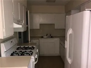a kitchen with a refrigerator stove and sink