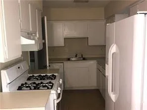 a kitchen with a refrigerator and a stove